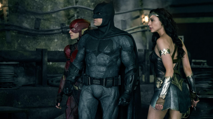 Batman, The Flash, and Wonder Woman are standing together, looking towards the right side.