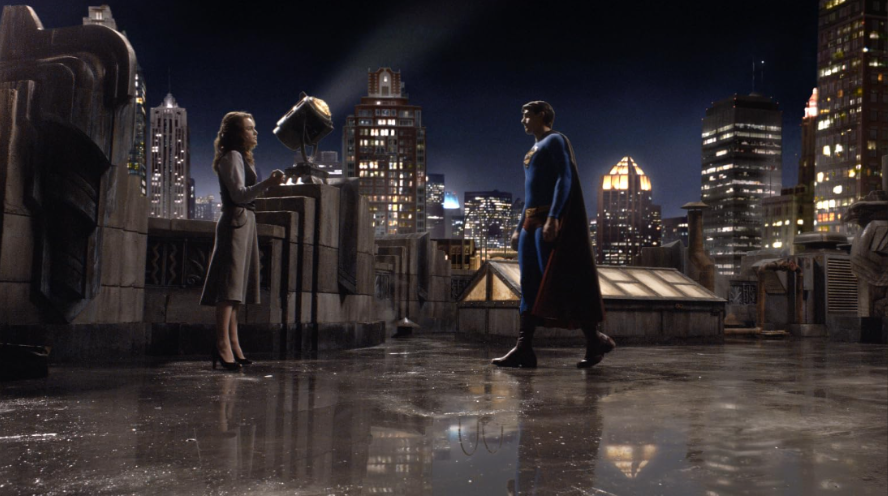 Superman is standing on a rooftop at night, facing Lois Lane.