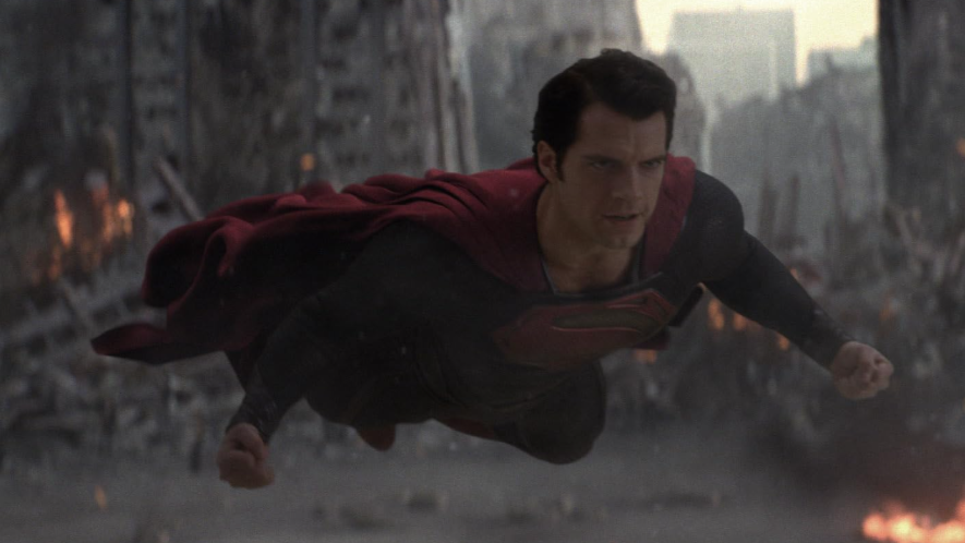 Superman is flying across a heavily damaged city
