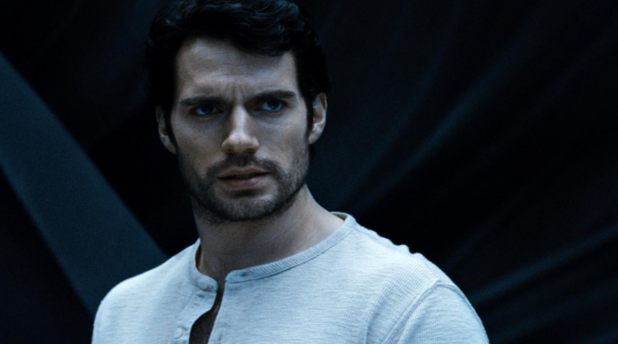 A close-up of Clark Kent. He is  looking intently to the side with a serious expression