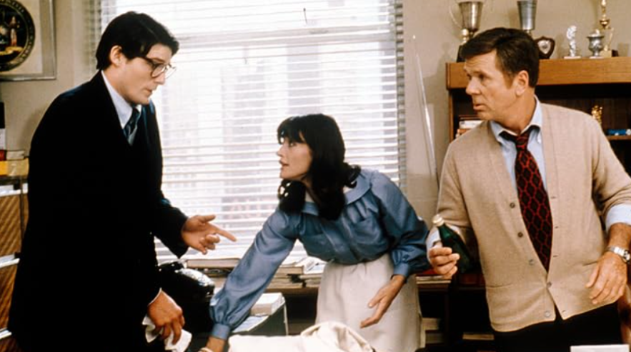 Clark Kent and Lois Lane are in an office with another man.