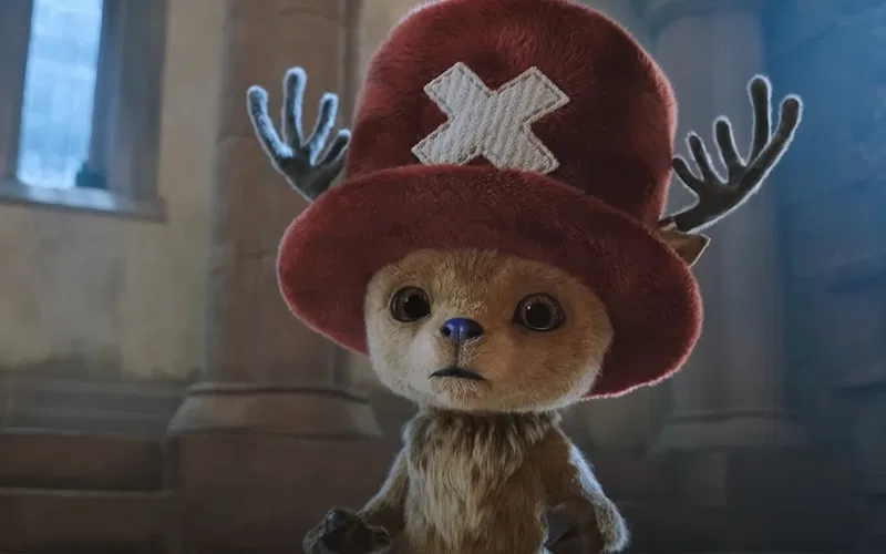 Chopper is standing cluelessly in a still from One Piece live-action