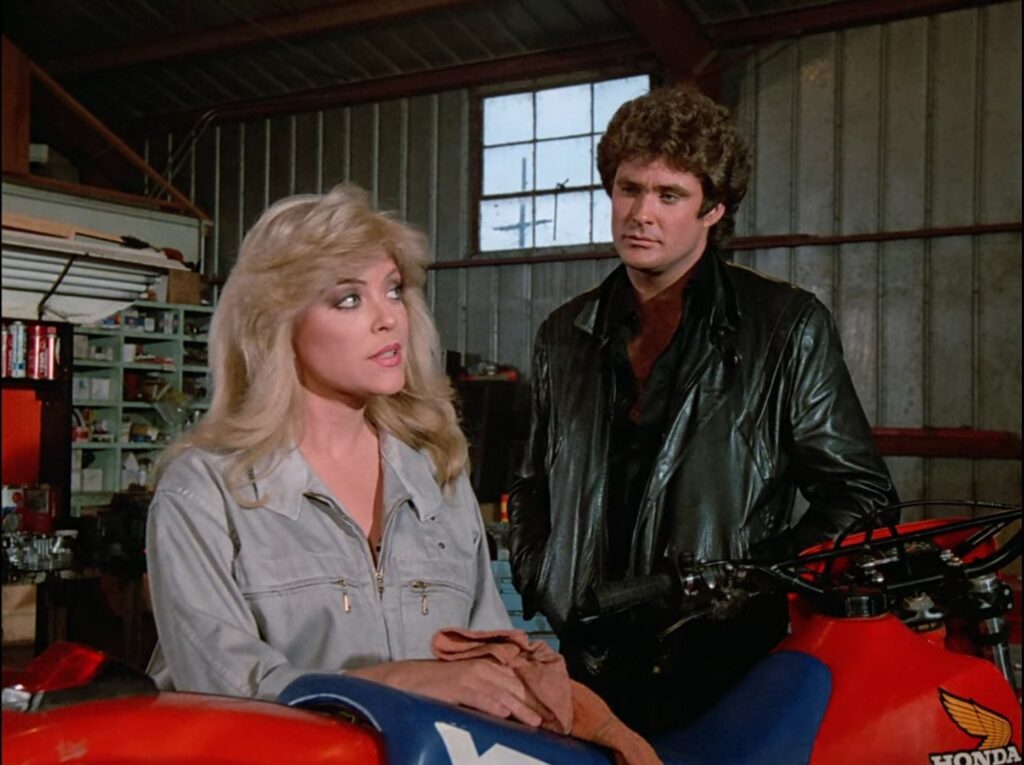 David Hasselhoff's Michael Knight in a still from Knight Rider, talking to Lydia Cornell in Knight Rider.