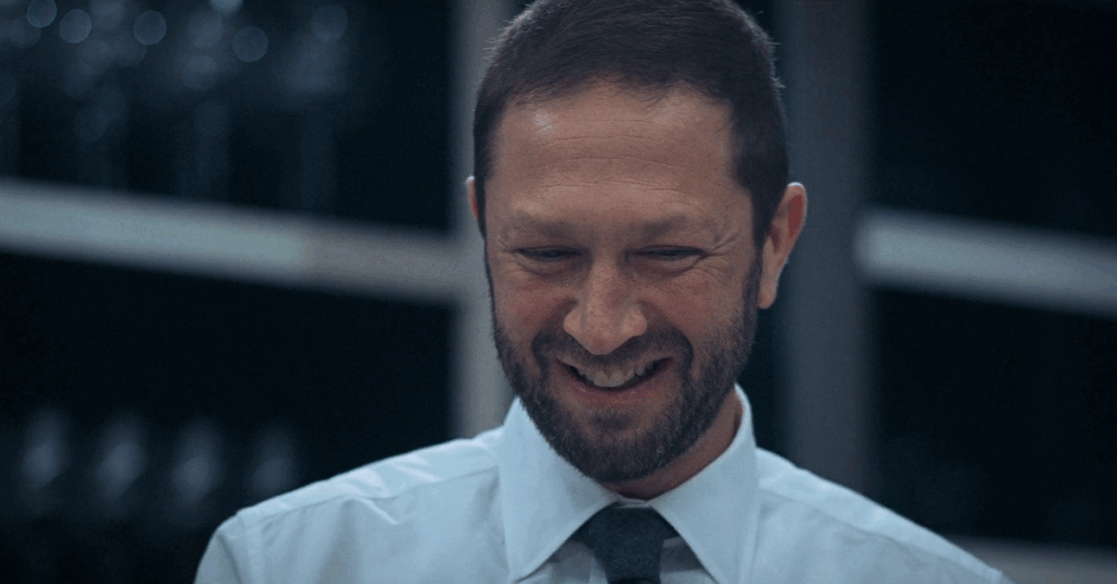 7 Essential ‘The Bear’ Episodes to Watch While You Wait for Season 4 4 Richie in a white shirt and black tie smiling.