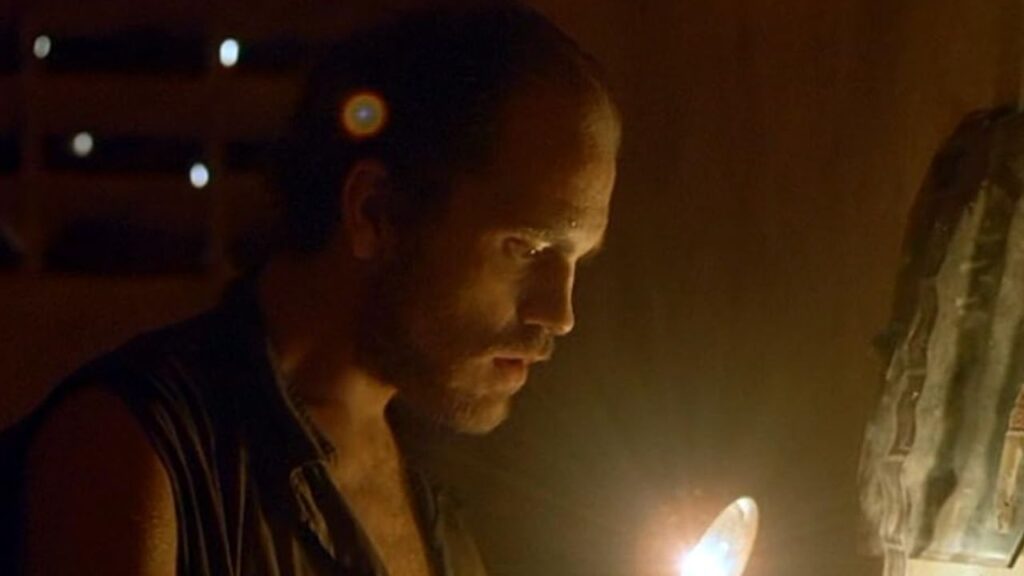 John Malkovich’s 10 Best Movies and the Role That Made Him Famous 2 John Malkovixh reading something using a flashlight