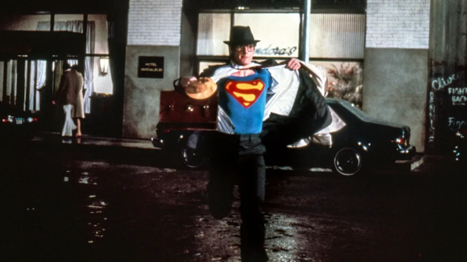 11 Things You Did Not Know About Superman’s Suit 9 Clark Kent, wearing his glasses and a hat, is shown mid-run, in the process of revealing his Superman suit.