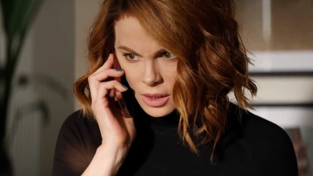 What Happened to Kate Beckinsale in Canary Black: Her Knee Injury and Lawsuit Against Producers Explained 1 Kate Beckinsale on the phone in a still from Canary Black