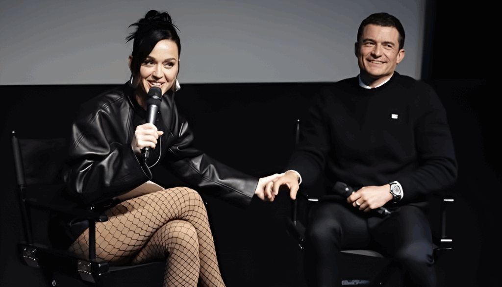Orlando Bloom’s Relationship With Katy Perry: What Went Wrong 5 Katy Perry and Orlando Bloom sitting together during what appears to be a panel discussion or interview. Perry is wearing a black leather outfit with fishnet stockings and holding a microphone, while Bloom is dressed in a black sweater. Both are smiling.