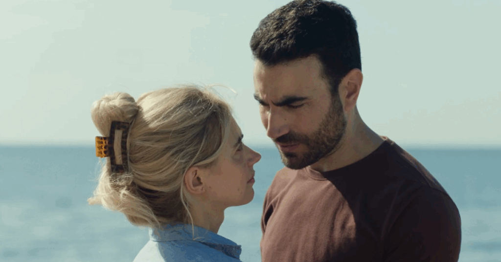 ‘All of You’ on Apple TV+: Release Date, Cast, Plot, and All You Need to Know 1 Imoen Poots with Brett Goldstein in front of a beach in All of You.