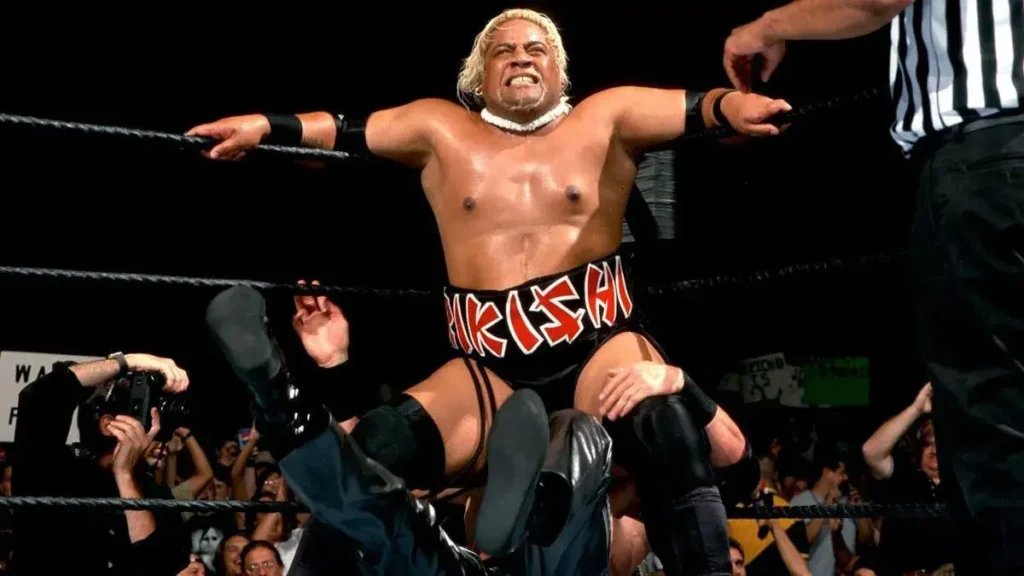 WWE Legend Is Furious With TKO Trying to Cut Roman Reigns' WWE Salary Rumor 2 Rikishi aka Solofa Fatu Jr. performing the Stink Face