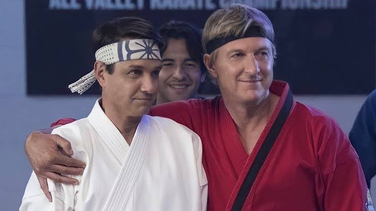 Cobra Kai Quietly Proved Mr. Miyagi Picked the Right Protégé, and It Wasn’t Daniel 2 William Zabka’s Johnny Lawrence with his hands on Ralph Macchio’s Daniel LaRusso’s shoulder