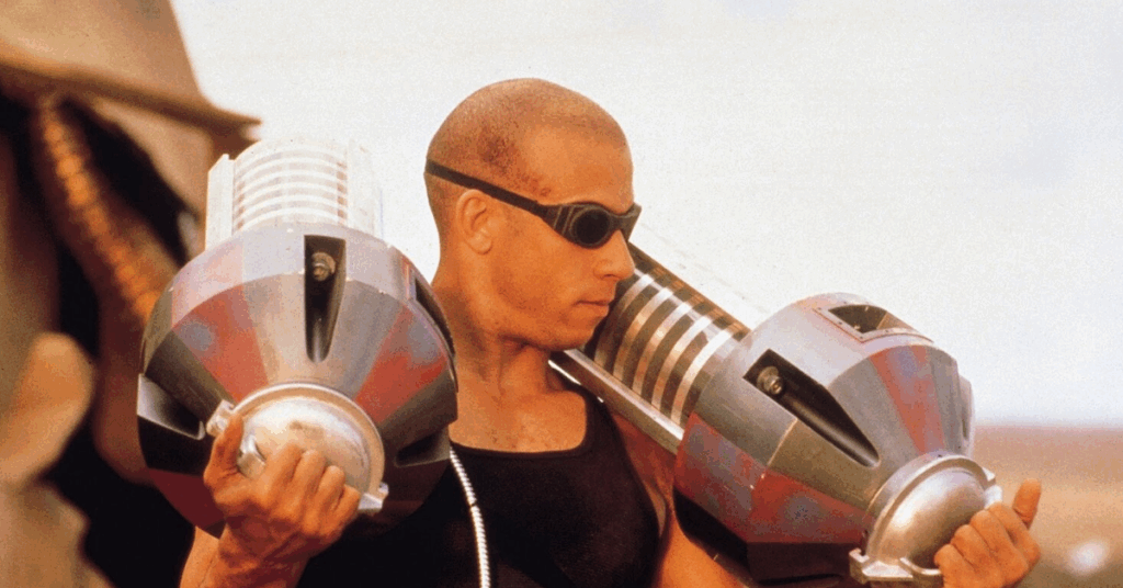 5 Best Vin Diesel Movies You Should Watch (Not Including Fast & Furious Franchise) 2 Vin Diesel holding a strange-looking machines over his shoulders.