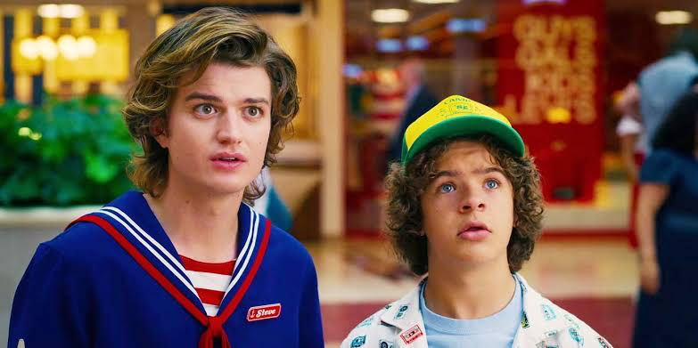 Stranger Things Season 4 Turns Best Friend Banter Into Lowkey Bullying for Steve 2 Steve and Dustin looking all innocent and listening to Robin in Stranger Things