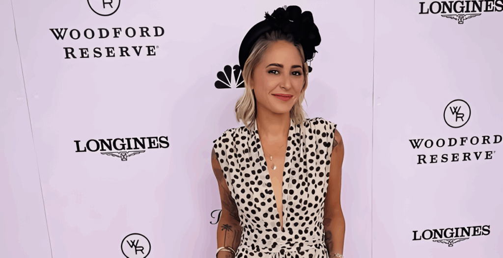 All 21 ‘Top Chef’ Winners and How Their Life Looks Like Today After Winning the Prize Money 14 Brooke Williamson in black and white polka dot jumpsuit with black fascinator hat, posing at a formal event with sponsor logos in background.