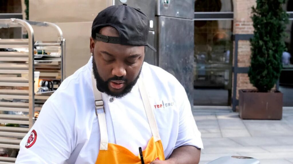All 21 ‘Top Chef’ Winners and How Their Life Looks Like Today After Winning the Prize Money 21 Tristen Epps-Long in white Top Chef apron and backwards cap, cooking while seated at an outdoor table.