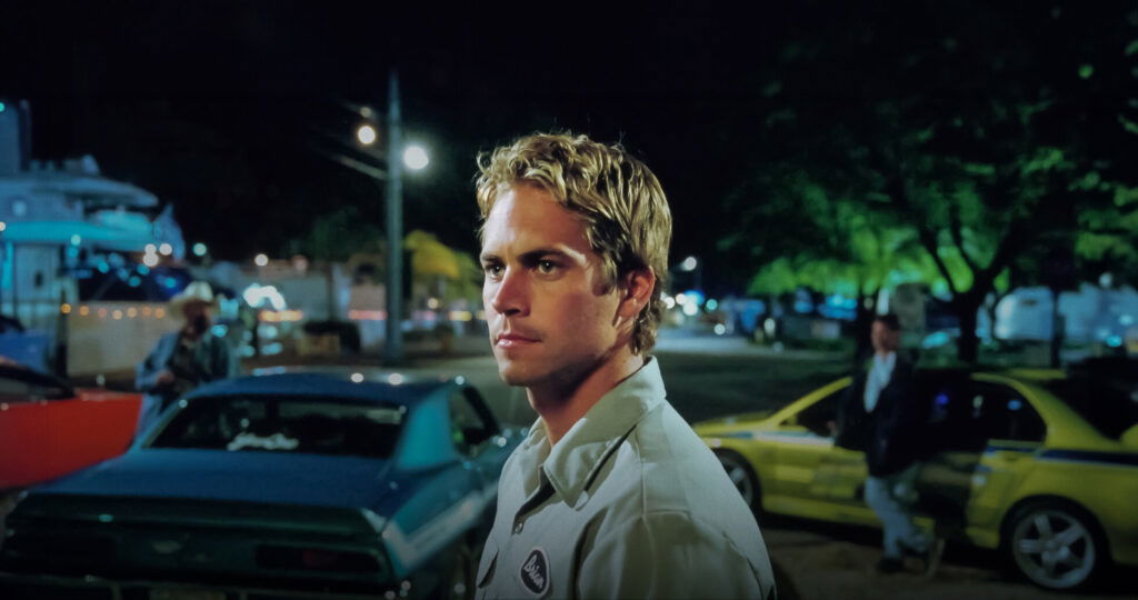 Paul Walker’s Earnings From the Fast and Furious Movies Before His Death, Explored 1 Paul Walker in a still from 2 Fast 2 Furious with a stern expression