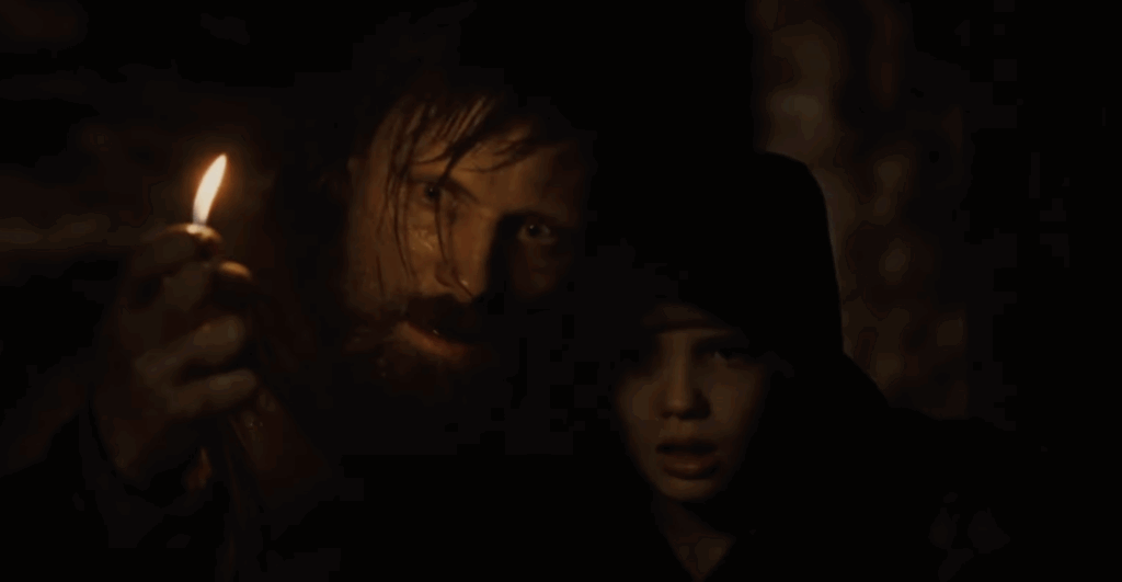 7 Best Viggo Mortensen Movies That Proved He’s More Than Aragorn 5 Viggo Mortensen in a dark room, holding a small light.