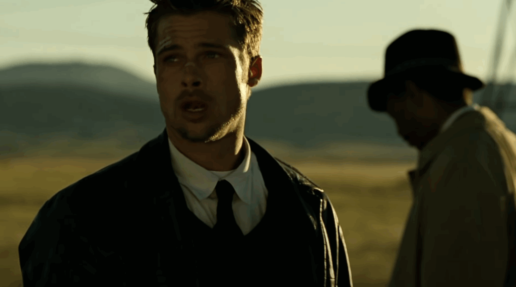 Brad Pitt in a black suit in Se7en. 