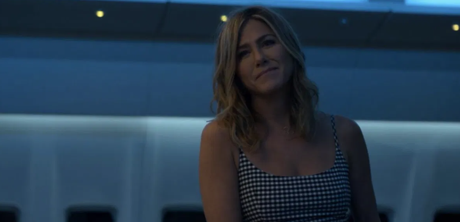 Jennifer Aniston standing inside a plane in Murder Mystery.