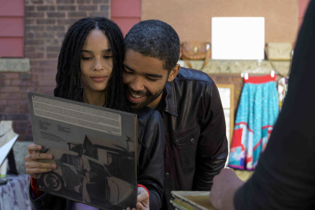Zoe Kravitz and Kingsley Ben-Adir in Hulu series, being snuggly and looking at a book.