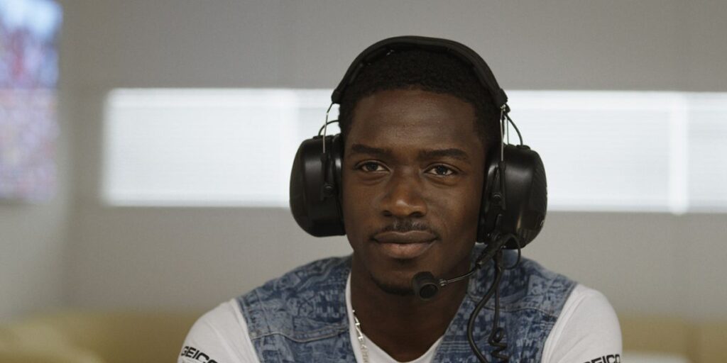 Damson Idris as Joshua Pearce wearing a headset in the F1 movie