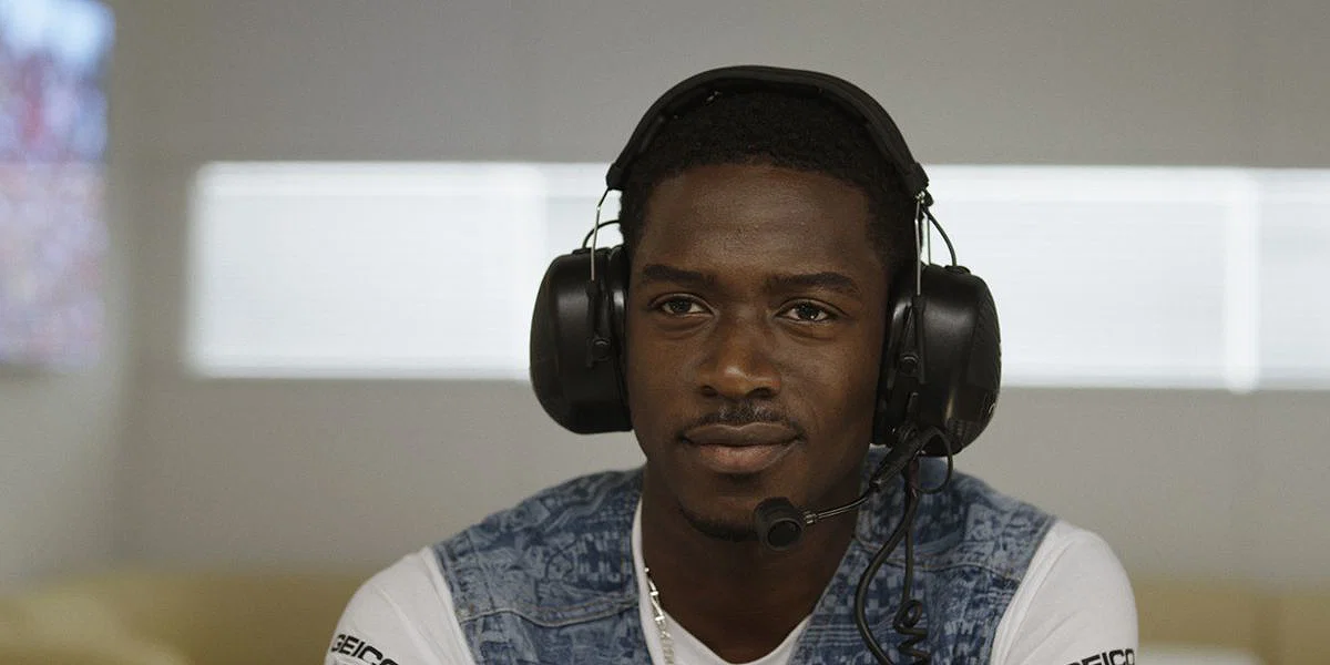 Damson Idris as Joshua Pearce wearing a headset in the F1 movie