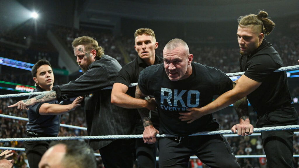 Randy Orton being controlled by security.