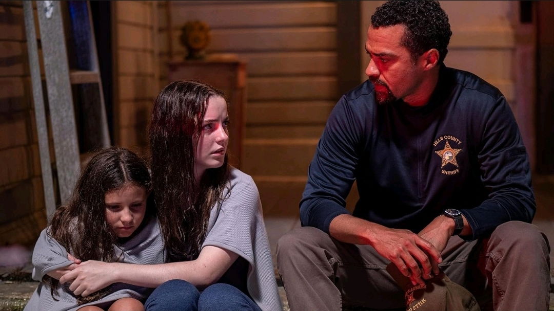 What We Hide Review — Mckenna Grace Anchors a Haunting and Profound Tale of Survival 2 Man sits on a porch with two girls