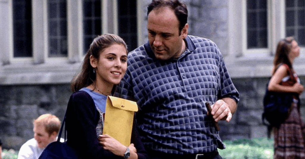 10 Best The Sopranos Episodes That Makes It Better Than Breaking Bad 11 Tony smoking a cigar with his daughter right beside him holding a yellow file.