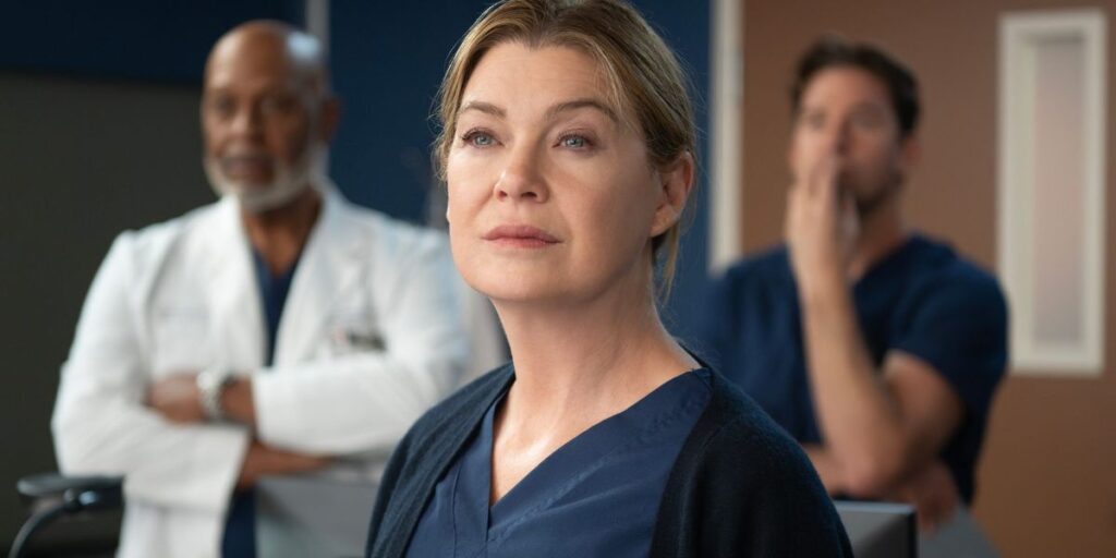 Ellen Pompeo as Meredith Grey in doctor's blue scrubs in Grey's Anatomy