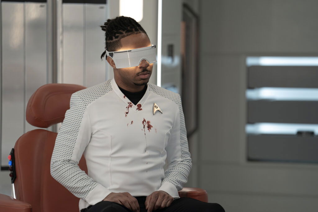 A still from Star Trek: Strange New Worlds Season 3 featuring Gamble wearing an eye mask