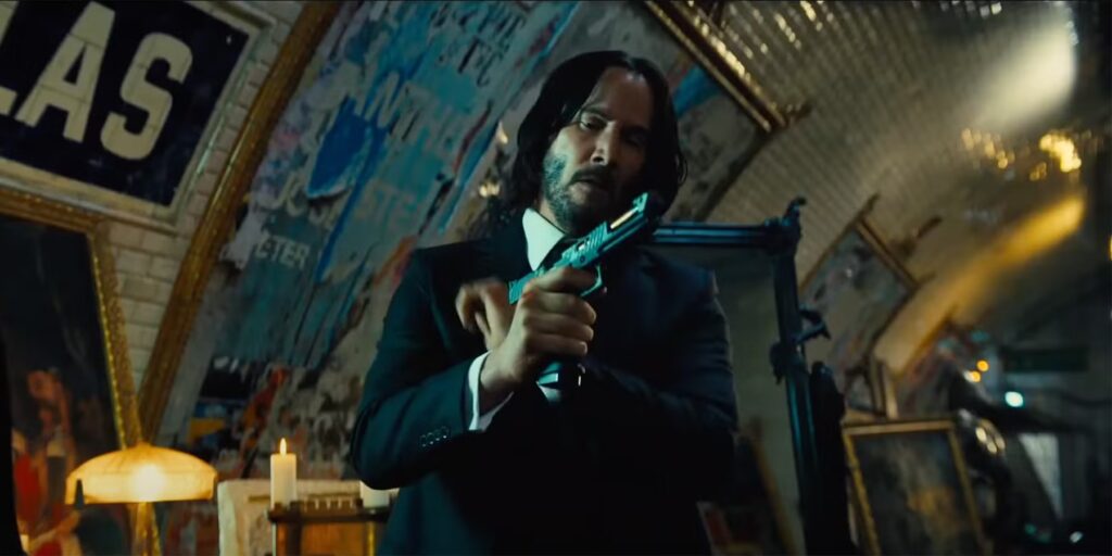 Keanu Reeves as John Wick checking his gun.