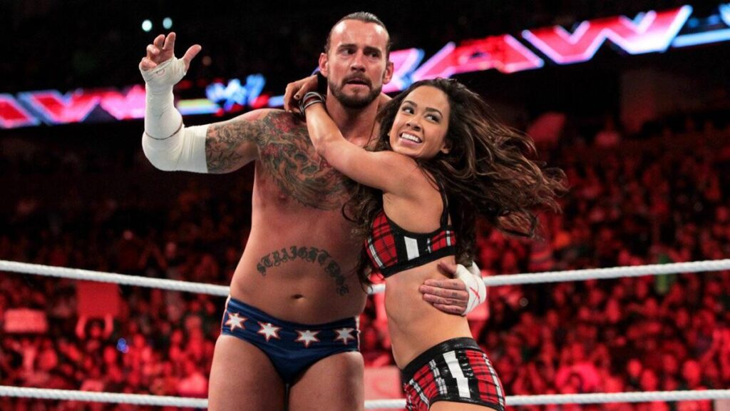 Aj Lee sharing a hug with CM Punk in the WWE ring