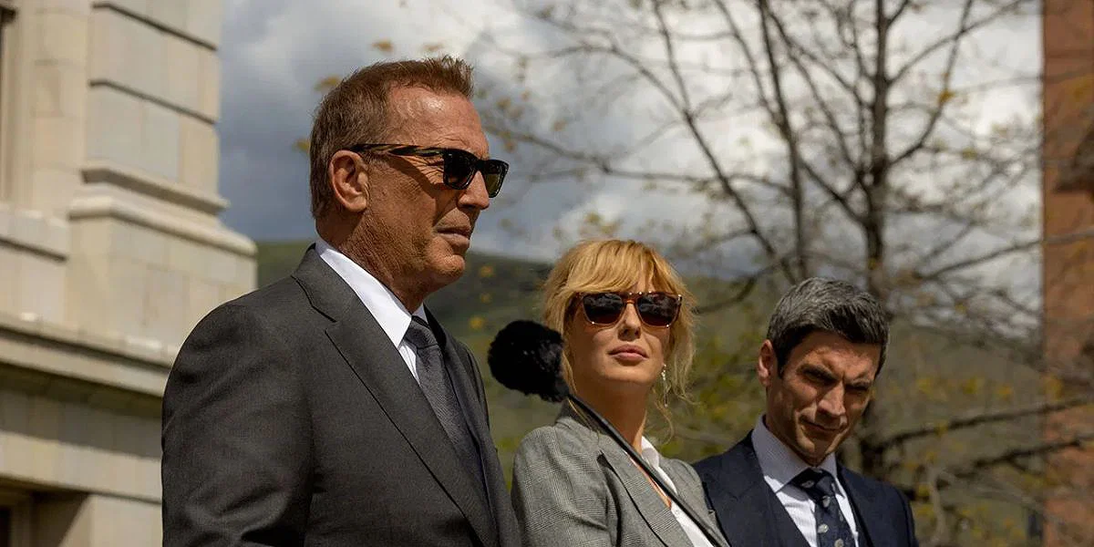 John Dutton (Kevin Costner) with children Beth (Reilly) and Jamie (Wes Bentley) stand side-by-side at the former's swearing in ceremony