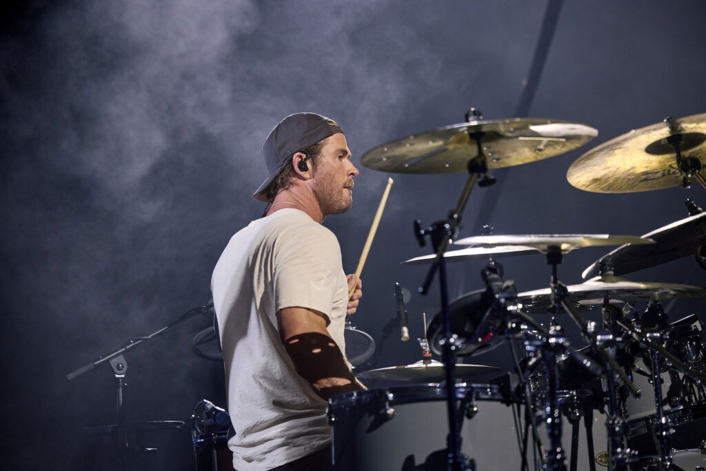 Chris Hemsworth's Nat Geo Documentary Is Threatening 'Alien: Earth' for Top Position in Hulu Streaming Charts 1 Chris Hemsworth playing drums at Ed Sheera's concert in Limitless Season 2