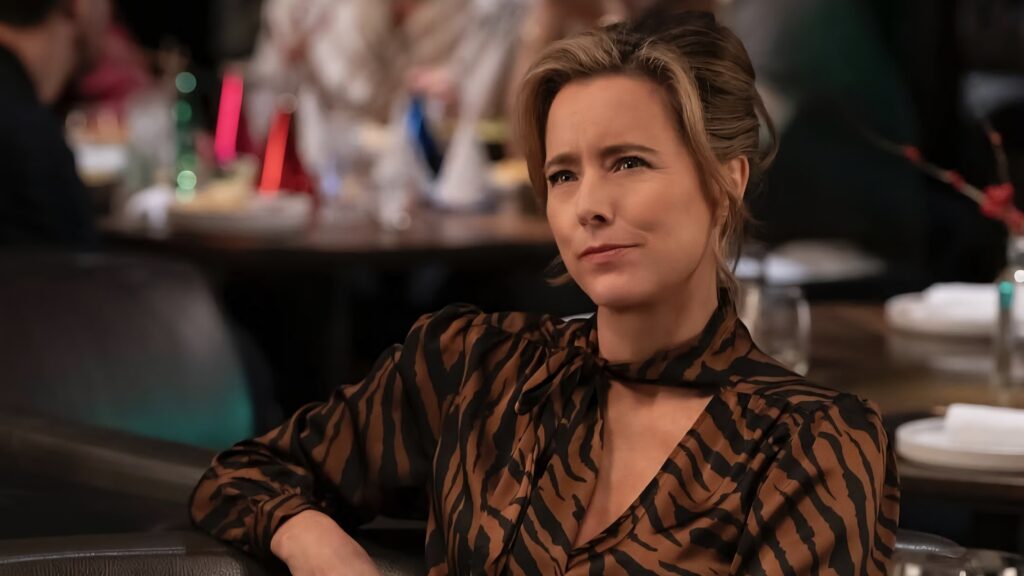 A woman looks smug at a restaurant