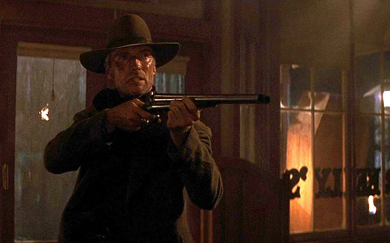 Clint Eastwood holding a shotgun