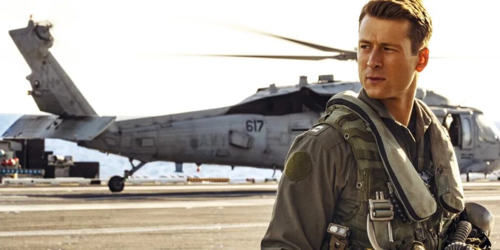 Glen Powell in Top Gun Maverick looking stern in airforce attire