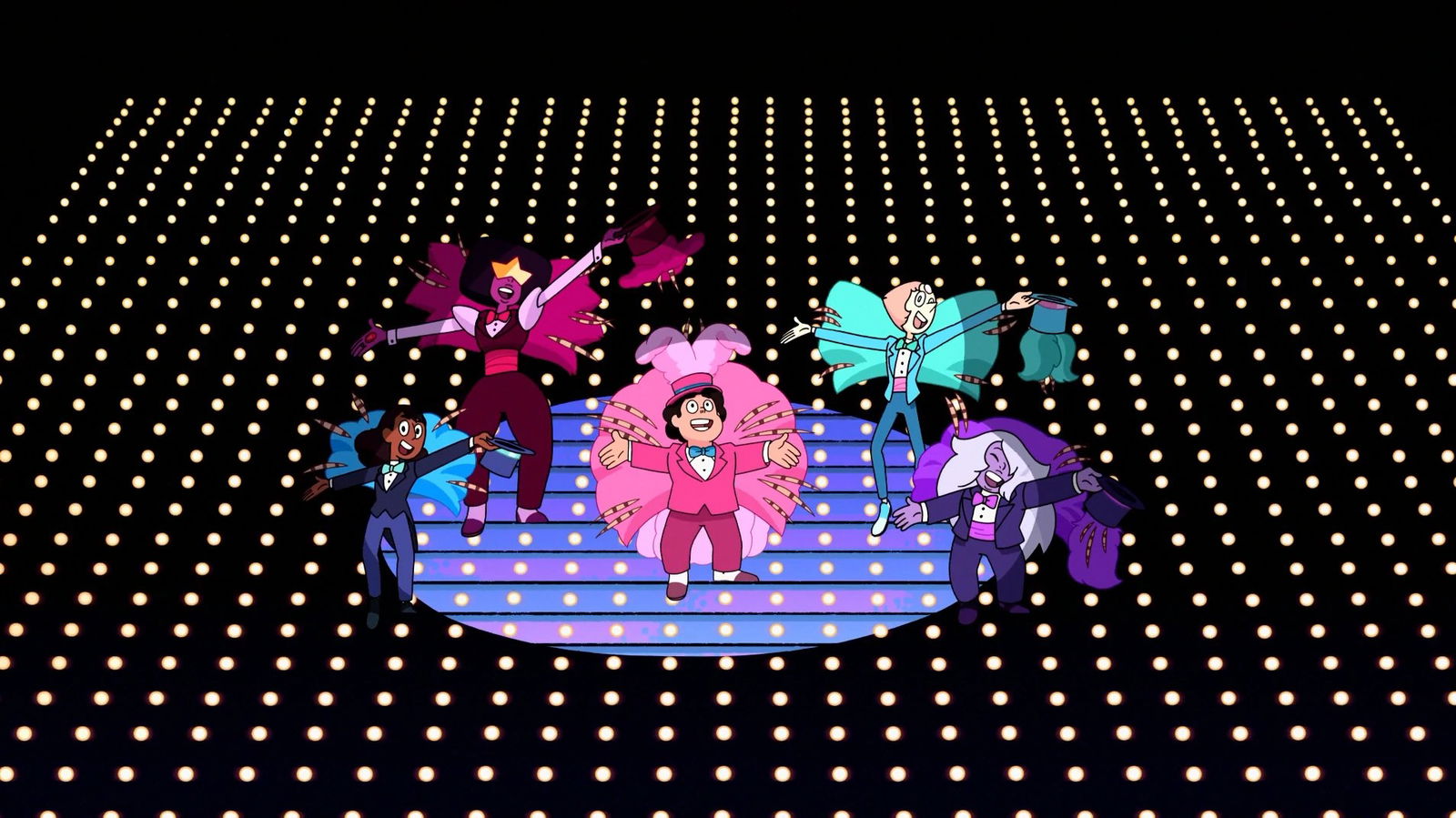 Five animated characters perform on a circular stage with dramatic lighting and a dotted backdrop - they appear to be in colorful, theatrical costumes with their arms raised in performance poses.