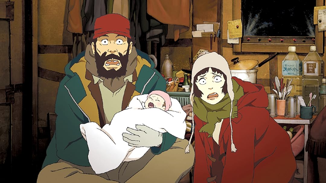 Gin in winter clothing holds a crying baby while Miyuki in a hooded cloak looks on with concern, in a rustic interior setting.