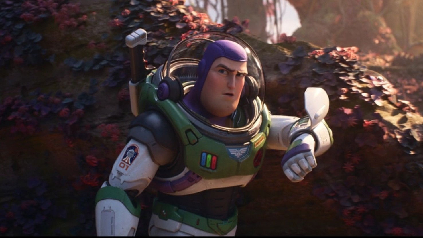 Buzz Lightyear lies on rocky ground in a dramatic pose, his space suit reflecting light against an alien landscape.