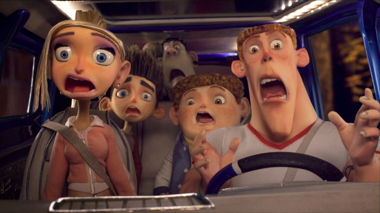 A group of scared-looking people, including Norman, Courtney, and Mitch, are crammed together in a vehicle, all with wide, frightened eyes.