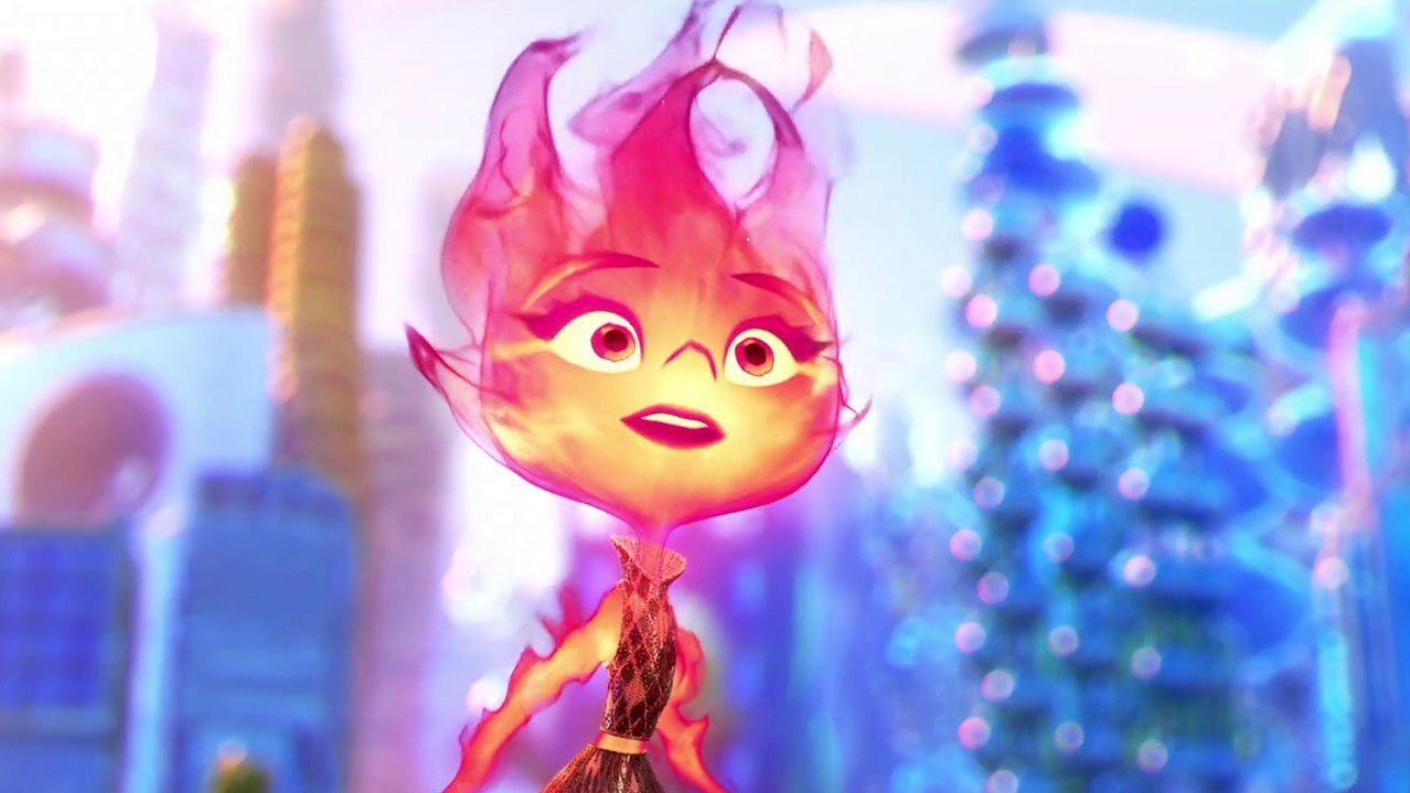 A close-up of Ember (an orange and pink fire element character) with a bright, animated expression against a soft blue and pink background.