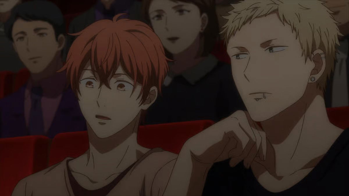 Two young men (Mafuyu Satō and Akihiko Kaji) sitting together, sharing an intimate conversation moment in a theater.