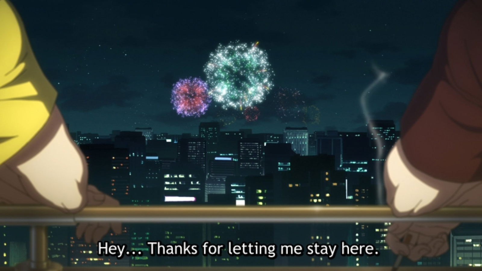 A nighttime scene showing two figures from behind looking at fireworks exploding in the sky over a city, with subtitle text reading "Hey... Thanks for letting me stay here."
