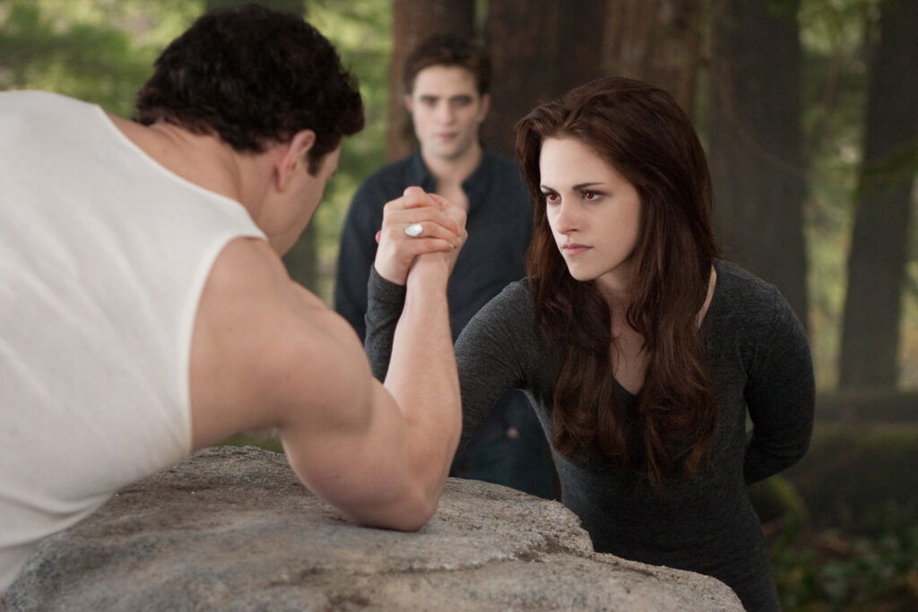 Bella is arm wrestling with a man