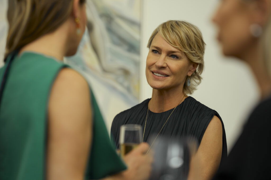 A smiling woman dressed in a black outfit