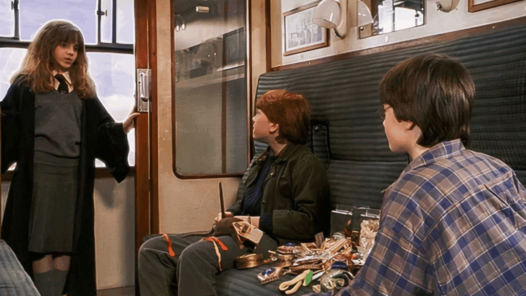 Hermione entering Harry and Ron’s compartment in the Hogwarts Express