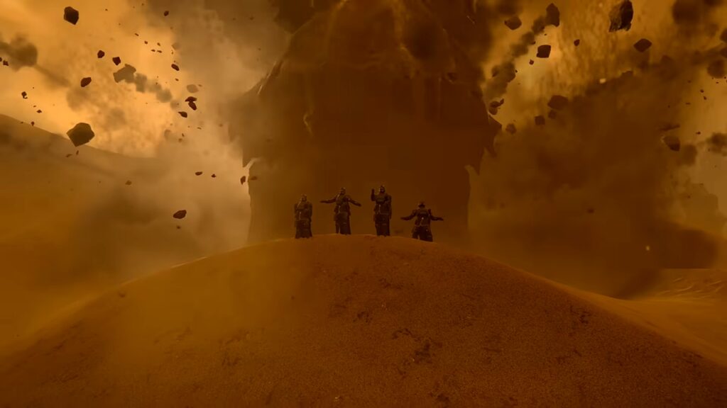 Divers posing in front of a Hive Lord in Helldivers 2.