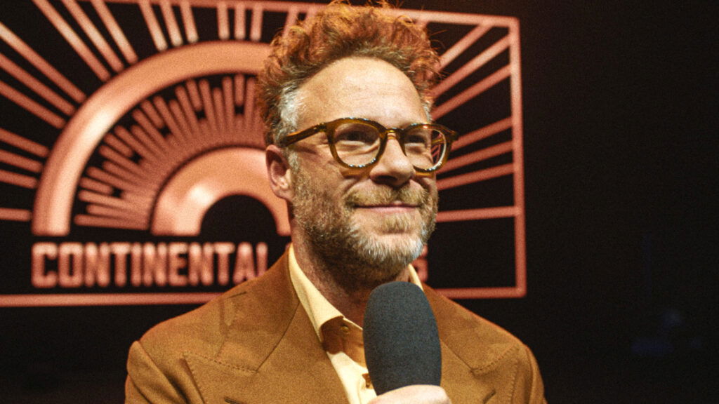 Seth Rogen holding a mic and smiling in The Studio